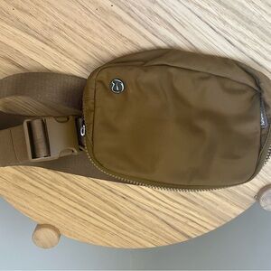 Two Lululemon Athletica Tan Belt Bag and black belt bag duo